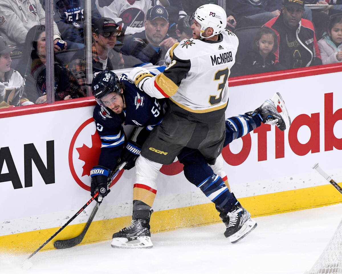 Vegas Golden Knights' Brayden McNabb (3) checks Winnipeg Jets' Mark Scheifele (55) during the f ...