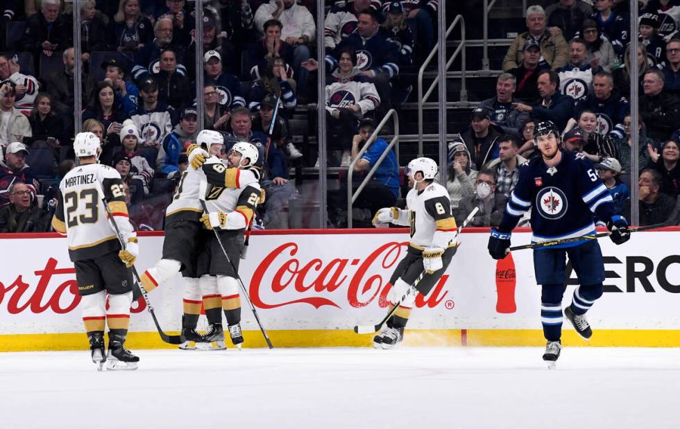 Vegas Golden Knights' Mark Stone (61) celebrates his goal against the Winnipeg Jets with Chandl ...