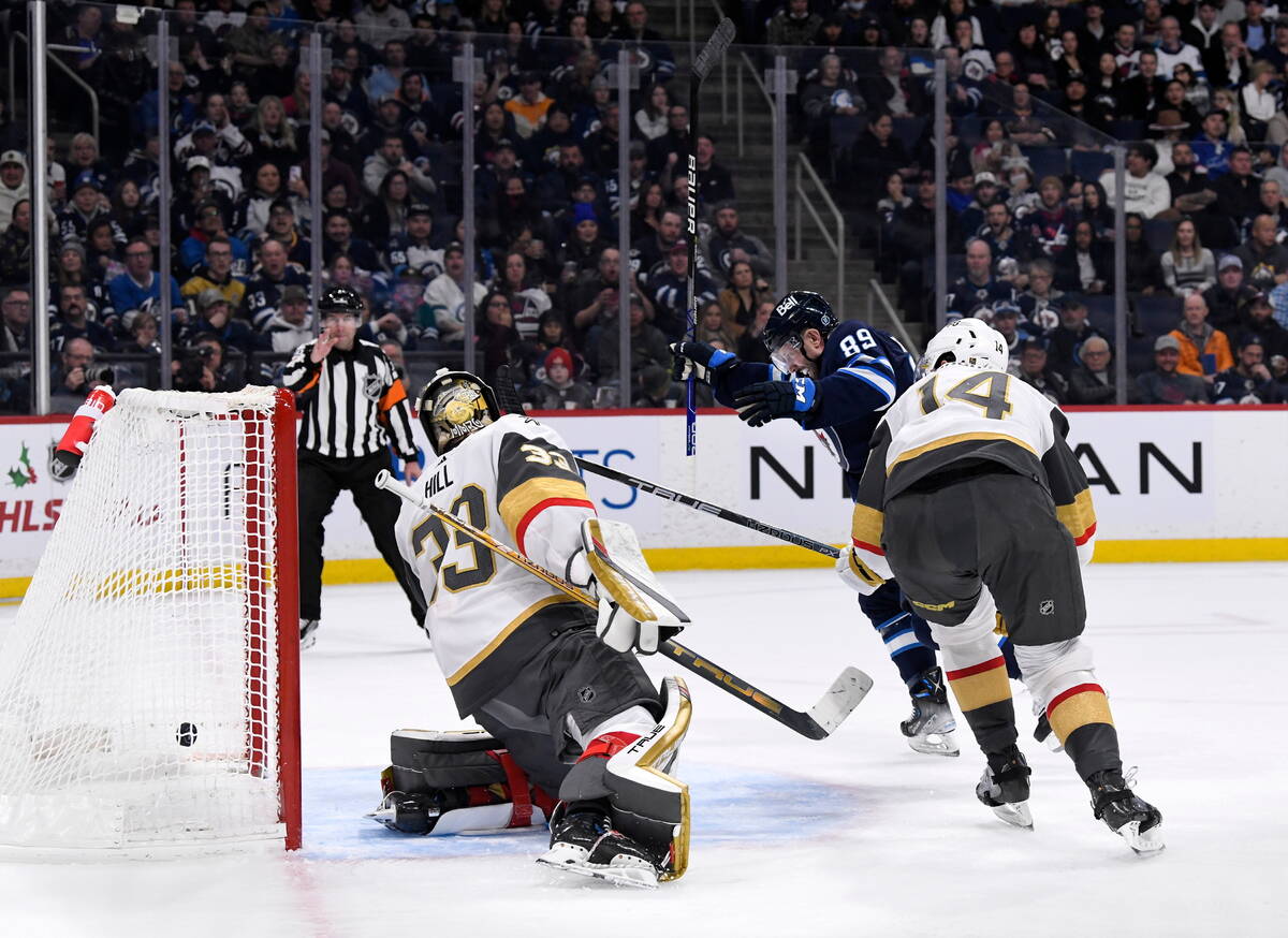 Winnipeg Jets' Sam Gagner (89) scores on Vegas Golden Knights goaltender Adin Hill (33) during ...