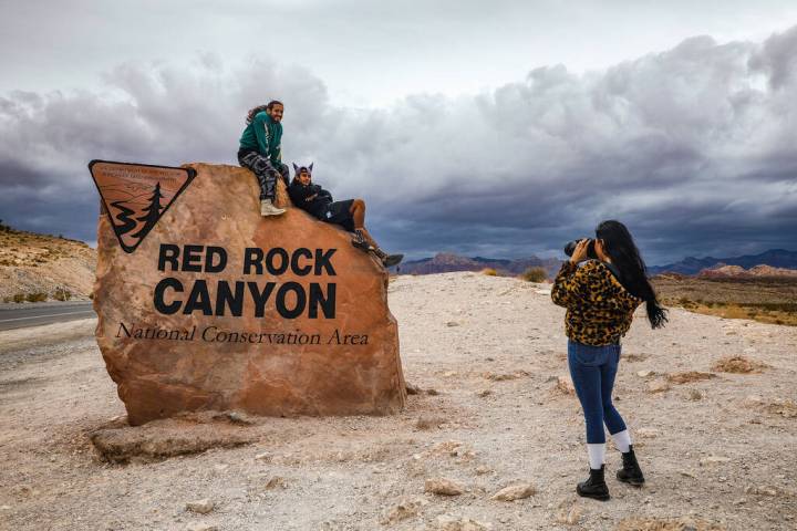 Marilyn Leiva, of California, takes a photo of her boyfriend, Jonathan Romo, left, and his brot ...