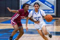 Desert Oasis guard La'Niah Hicks (1) keeps a tight defense on Desert Pines guard Destiny Sao Ma ...