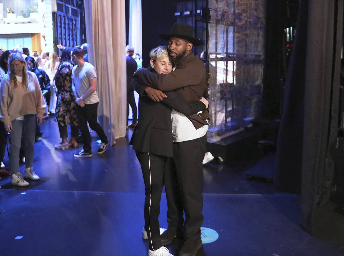 FILE - In this photo released by Warner Bros., talk show host Ellen DeGeneres embraces Stephen ...