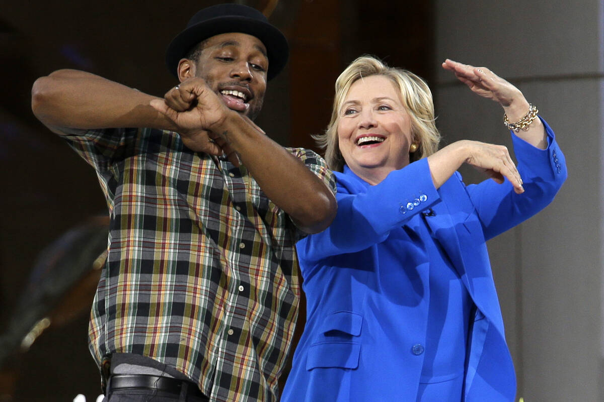 FILE - Democratic presidential candidate Hillary Rodham Clinton, right, practices her dance mov ...