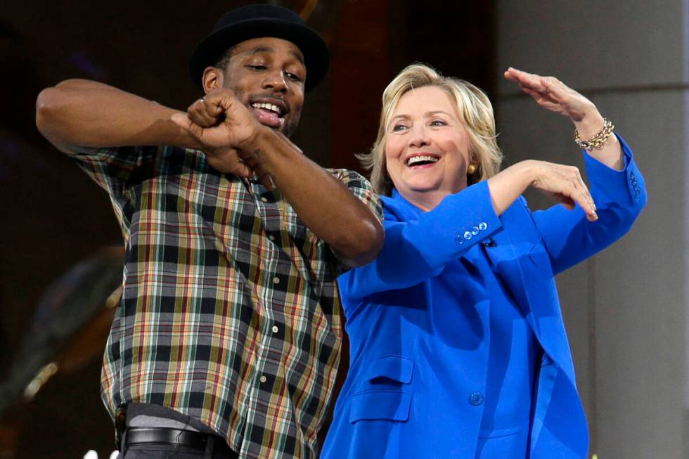 FILE - Democratic presidential candidate Hillary Rodham Clinton, right, practices her dance mov ...