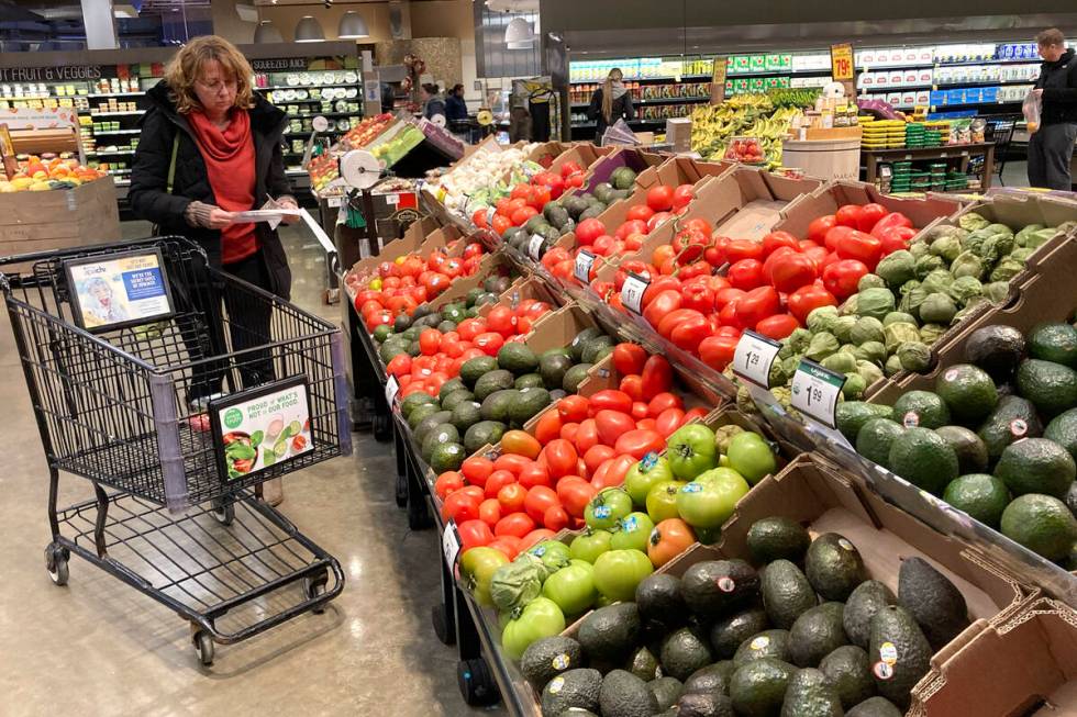 FILE - Shoppers pick out items at a grocery store in Glenview, Ill., Saturday, Nov. 19, 2022. T ...