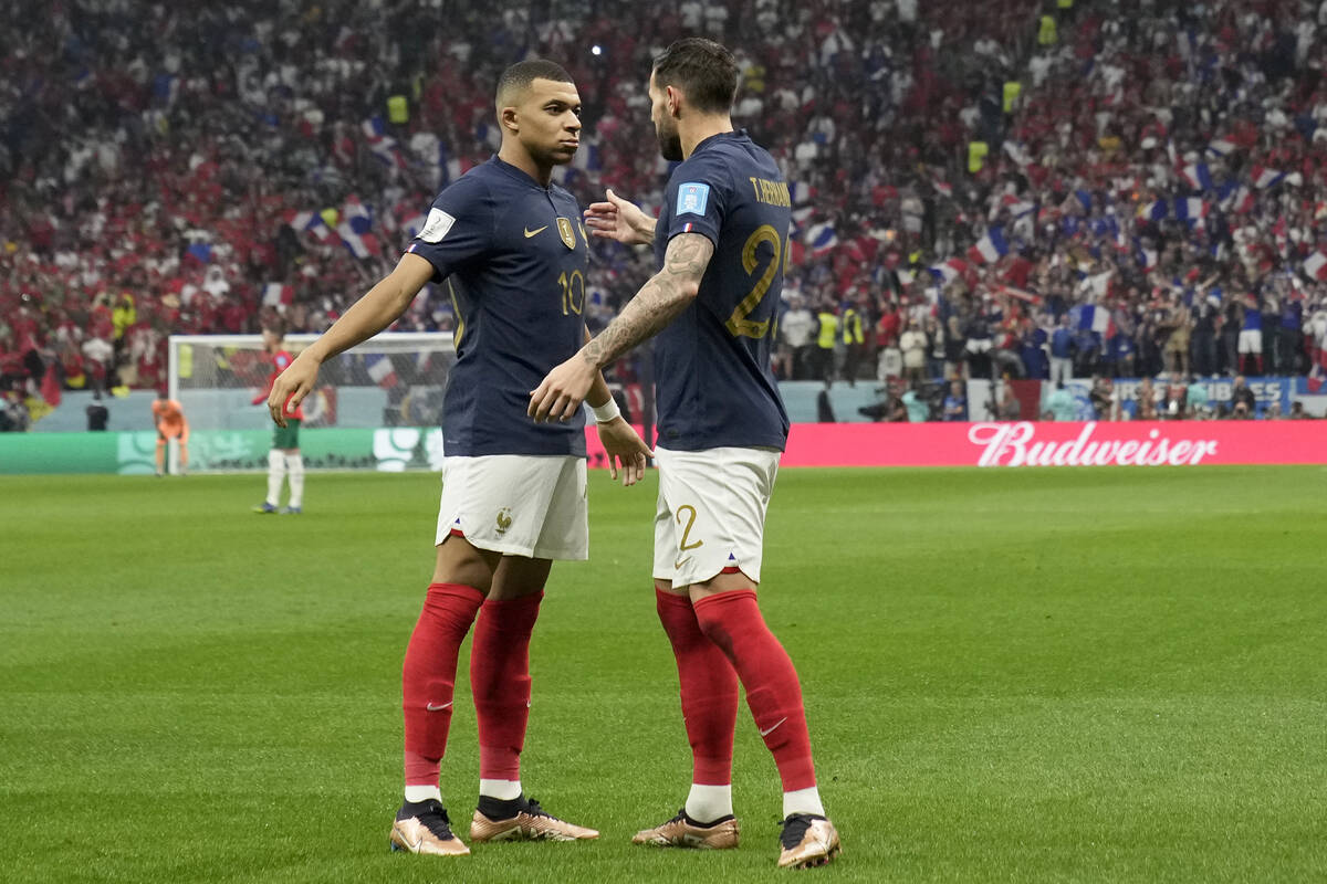France's Theo Hernandez, right, celebrates with Kylian Mbappe after scoring the opening goal du ...