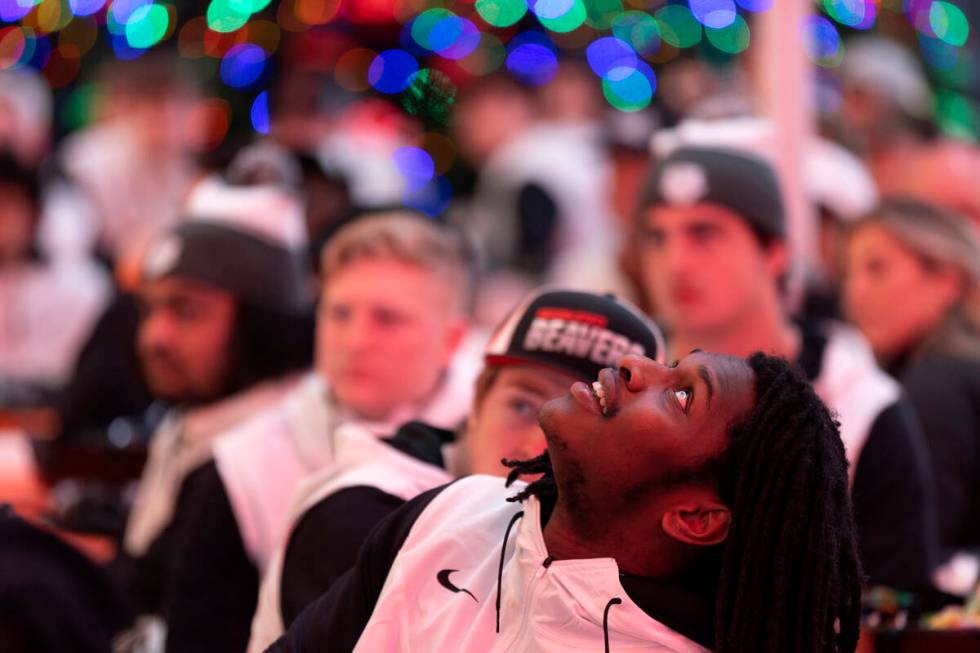 An Oregon State player watches game highlights on the ceiling during a welcome reception ahead ...