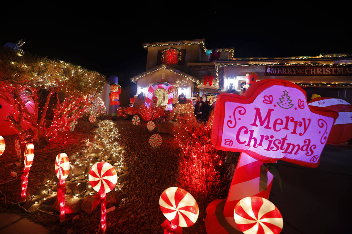 People visit the Candy Cane House, Friday, Dec. 16, 2022, in Henderson. Victor Cardenas and his ...