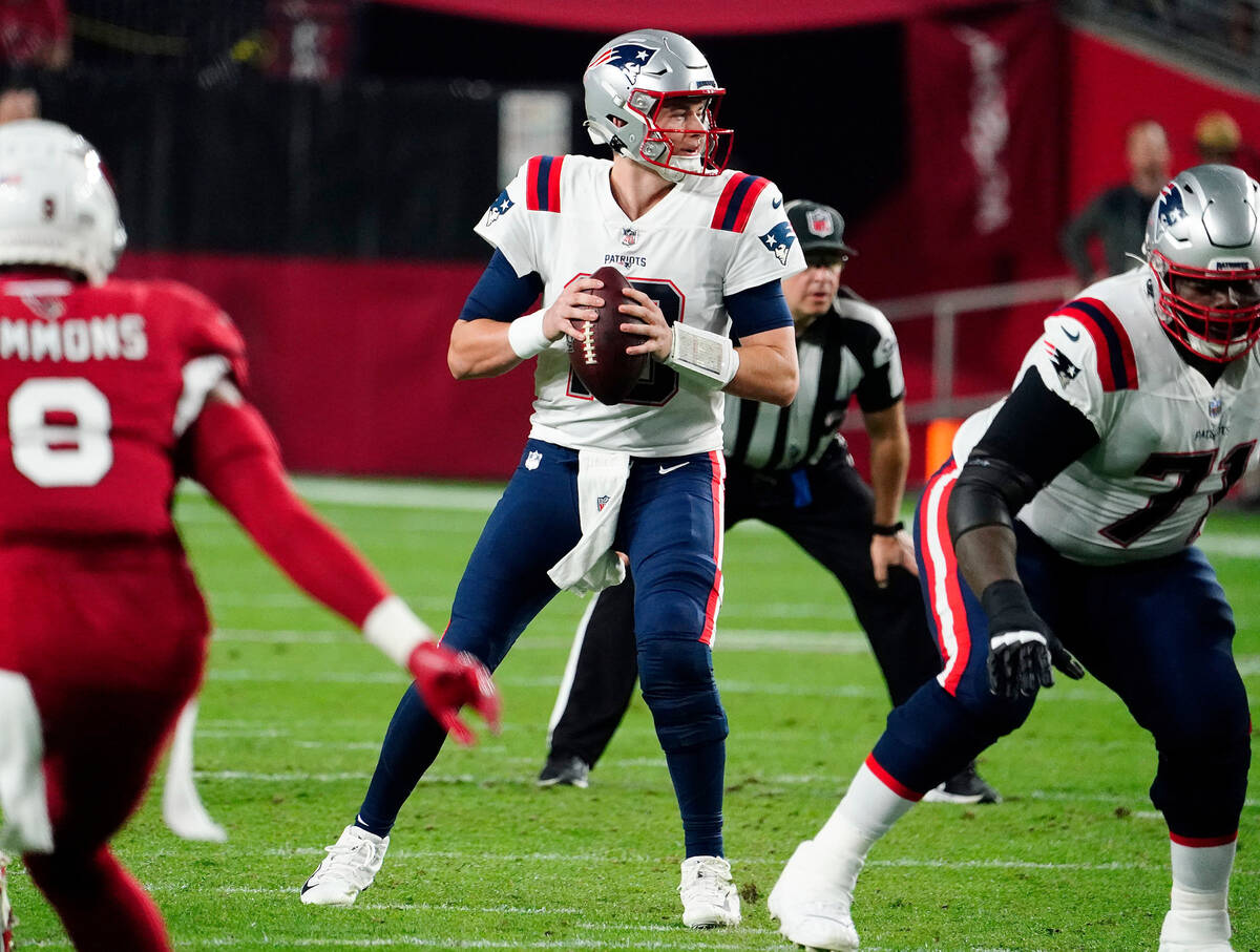 New England Patriots quarterback Mac Jones (10) looks to pass against the Arizona Cardinals dur ...
