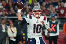 New England Patriots quarterback Mac Jones (10) throws the ball against the Arizona Cardinals d ...