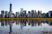 FILE - New York's Lower Manhattan skyline, including the One World Trade Center, left, is refle ...
