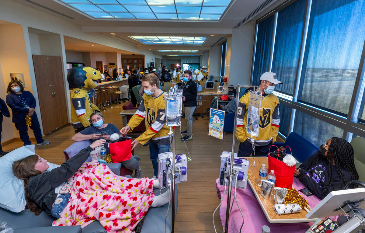 William Karlsson (81) and Alec Martinez (23) chat with patients and parents as the Cure 4 The K ...