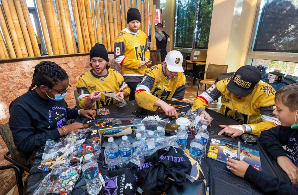 Patient McKinley Eisenberg, 12, builds a Lego character with Jonathan Marchessault (81), Phil K ...