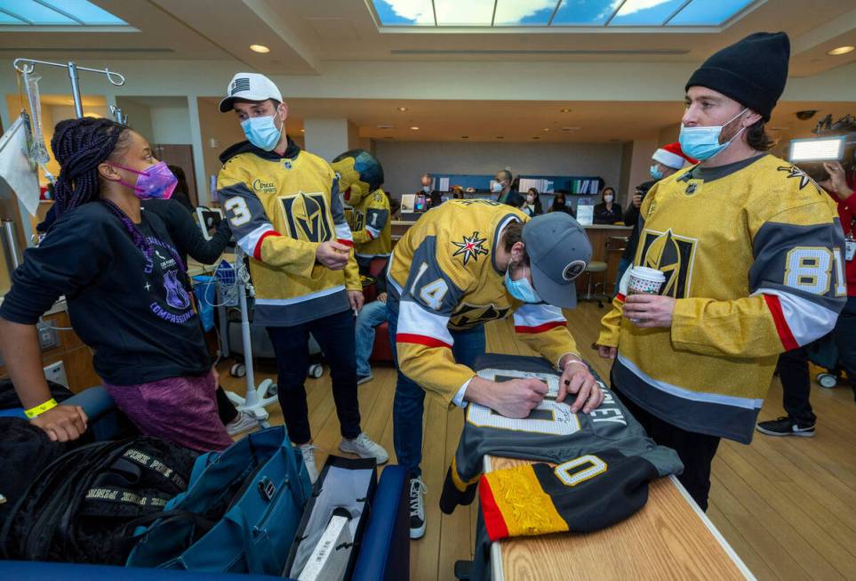 Patient Mykala Earley has a jersey signed by Alec Martinez (23), Nicolas Hague (14) and Jonatha ...