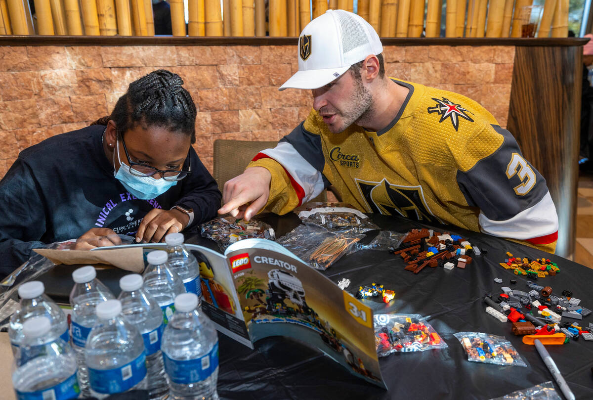 Patient McKinley Eisenberg, 12, and Brayden McNabb (3) work to build a Lego character as the Cu ...