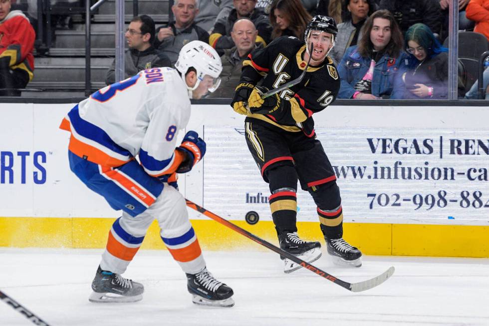 Vegas Golden Knights right wing Reilly Smith (19) shoots past New York Islanders defenseman Noa ...