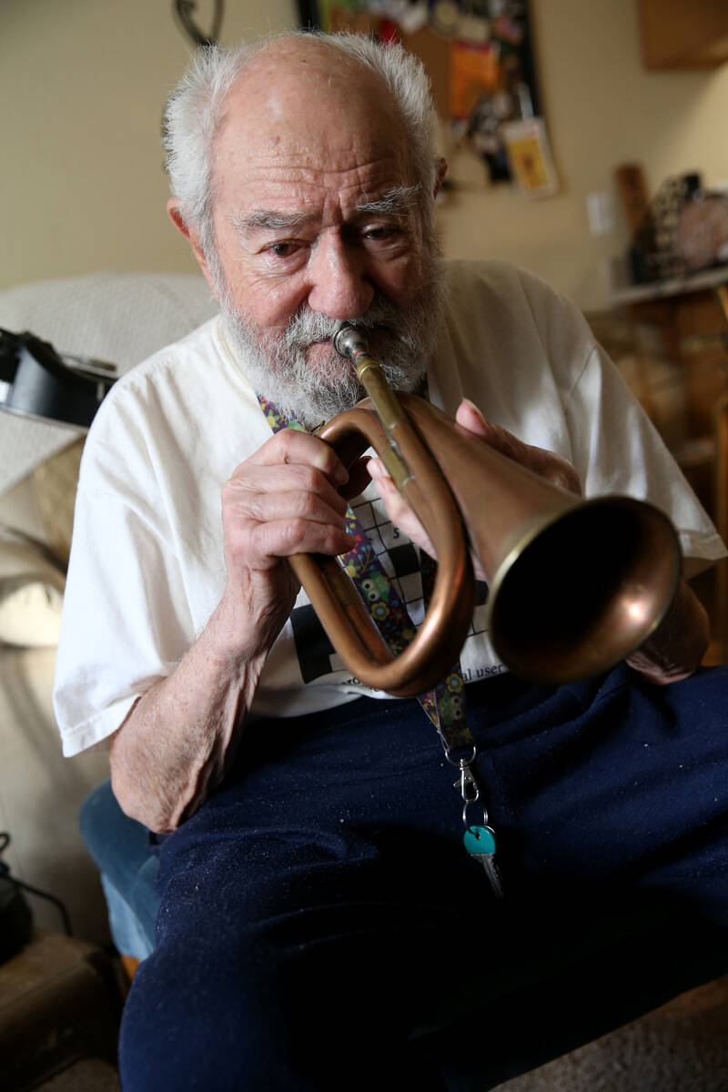 U.S. Army Air Corps veteran and ex-prisoner of war Vincent Shank, 103, plays the bugle he used ...