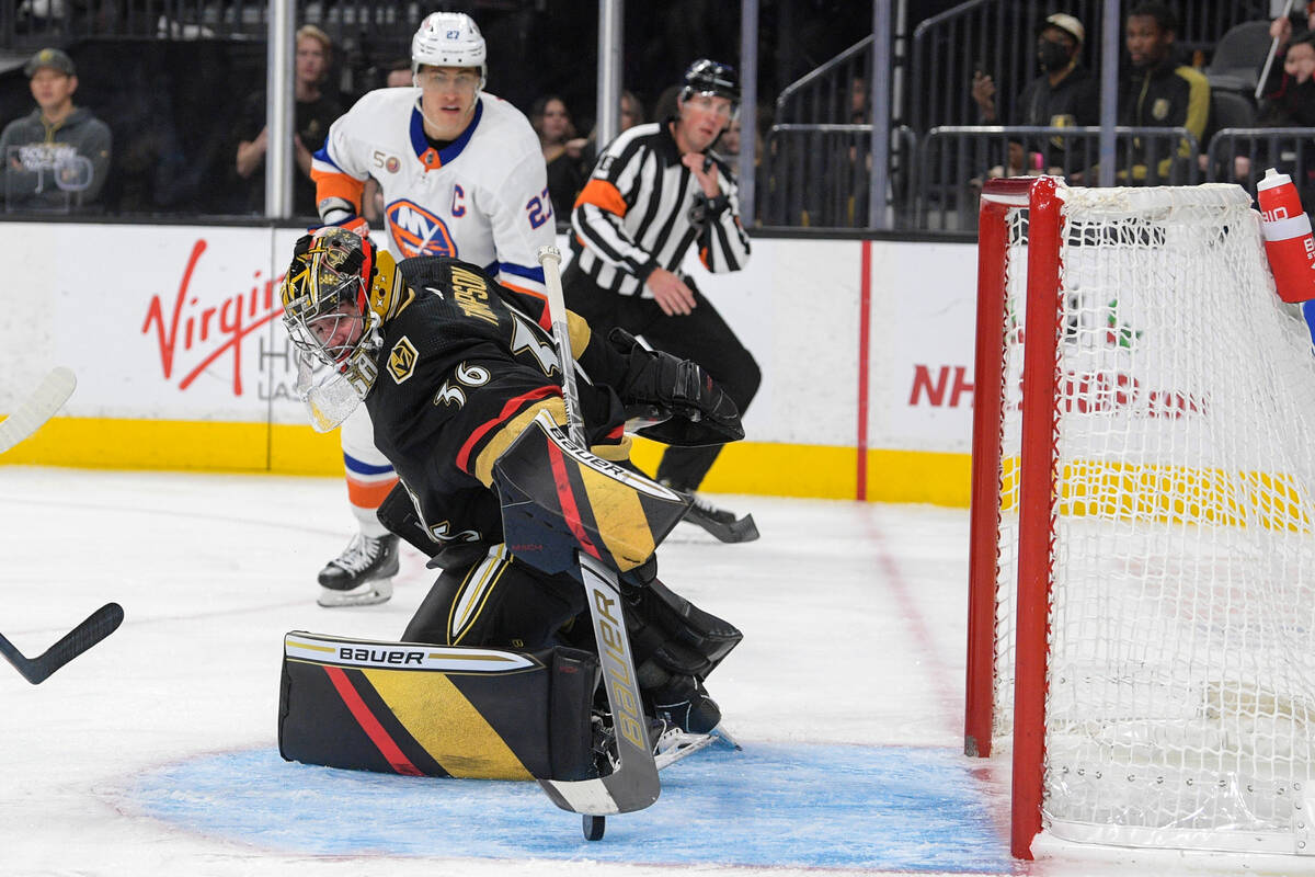 Vegas Golden Knights goaltender Logan Thompson (36) stops a shot by the New York Islanders duri ...