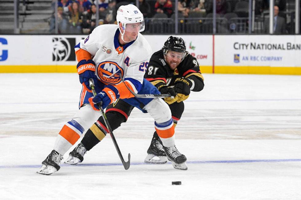 Vegas Golden Knights center Jonathan Marchessault (81) defends New York Islanders center Brock ...