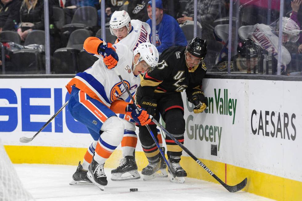 New York Islanders left wing Anders Lee (27) and Vegas Golden Knights defenseman Alec Martinez ...