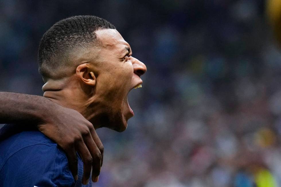 France's Kylian Mbappe celebrates scoring his side's second goal during the World Cup final soc ...