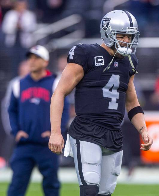 Raiders quarterback Derek Carr (4) yells on the field during warm ups before the first half of ...