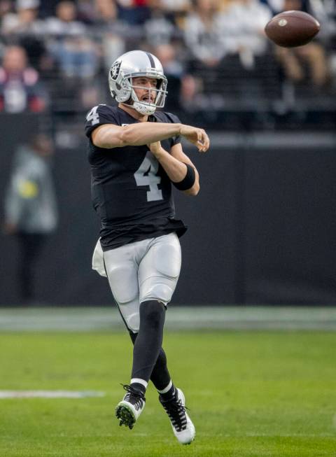 Raiders quarterback Derek Carr (4) throws on the run during the first half of an NFL game at Al ...