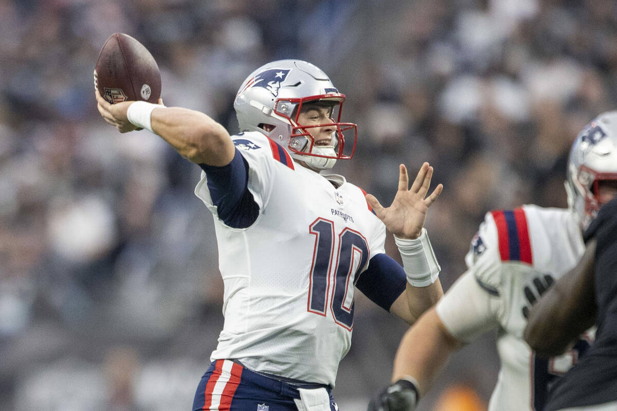 New England Patriots quarterback Mac Jones (10) throws against the Raiders during the first hal ...
