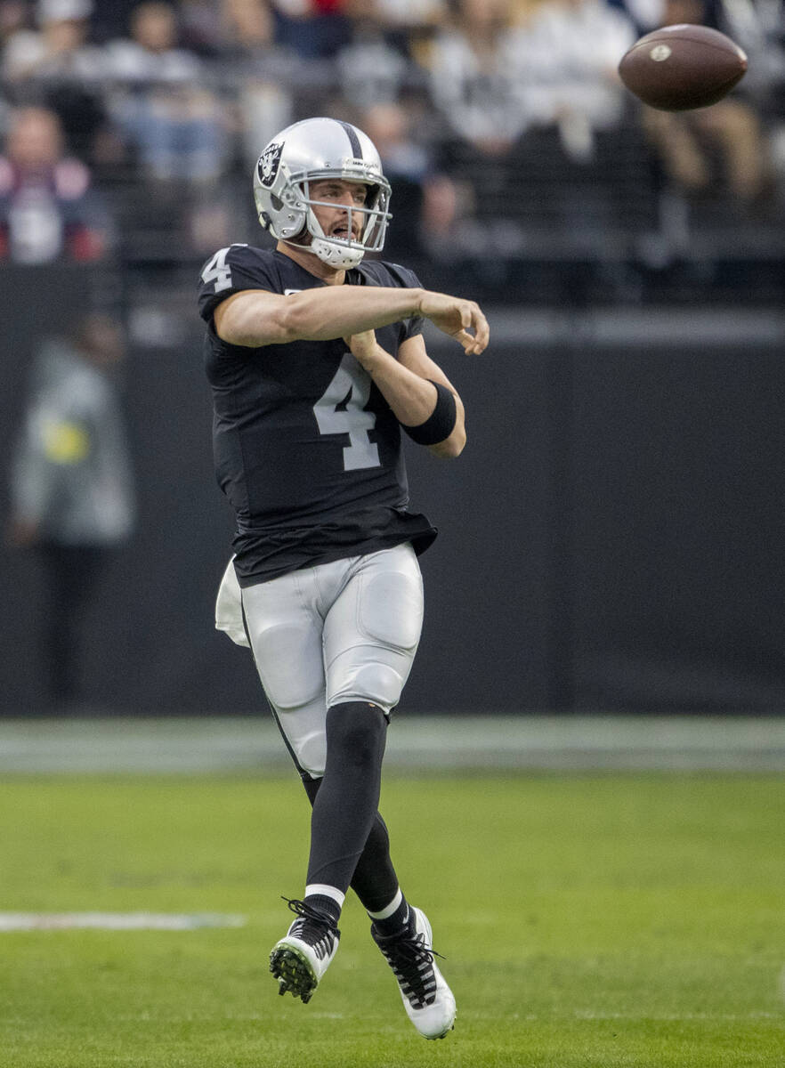 Raiders quarterback Derek Carr (4) throws on the run during the first half of an NFL game at Al ...