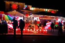 People visit the Candy Cane House, Friday, Dec. 16, 2022, in Henderson. (Chitose Suzuki/Las Veg ...