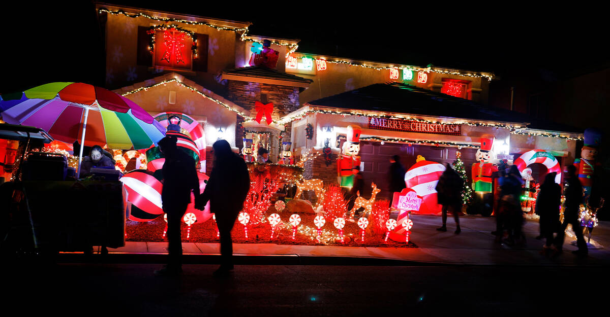 People visit the Candy Cane House, Friday, Dec. 16, 2022, in Henderson. (Chitose Suzuki/Las Veg ...