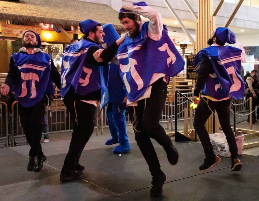 The Dancing Dreidels perform for the audience during a ceremony to celebrate the first night of ...