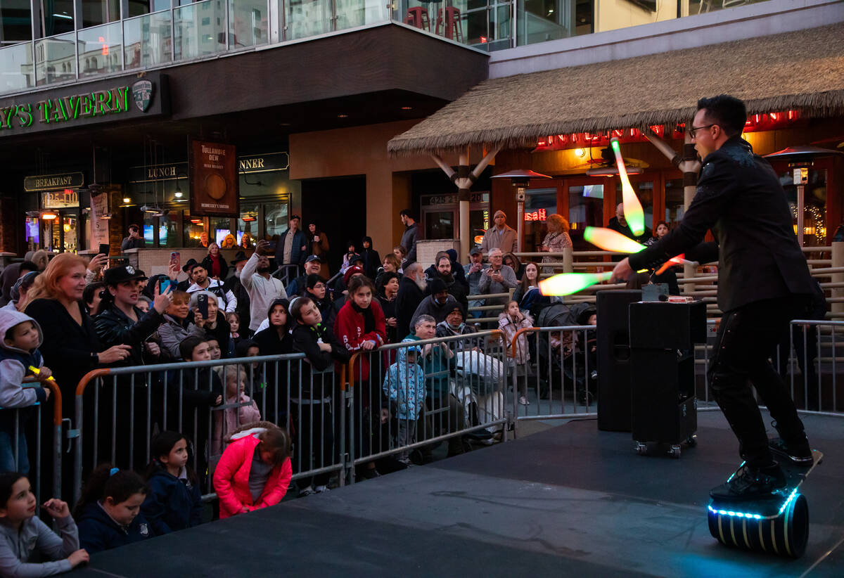 Chuck ‘Magic Chad’ Lane, magician, juggles for the crowd during a celebration of ...