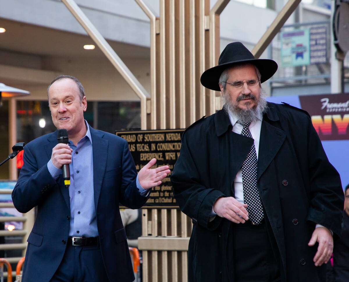 Andrew Simon, left, CEO of Fremont Street Experience, and Rabbi Shea Harlig, right, from Chabad ...