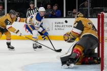 Buffalo Sabres center Dylan Cozens (24) takes a shot on Vegas Golden Knights goaltender Adin Hi ...