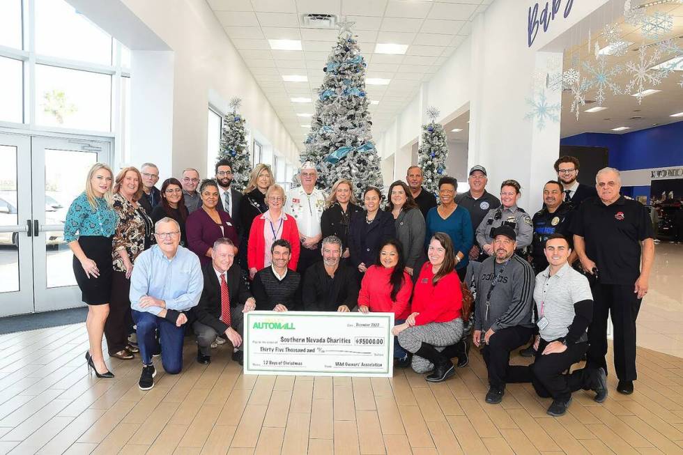 On the left kneeling are Valley Automall board members Greg Heinrich, dealer principal Henderso ...