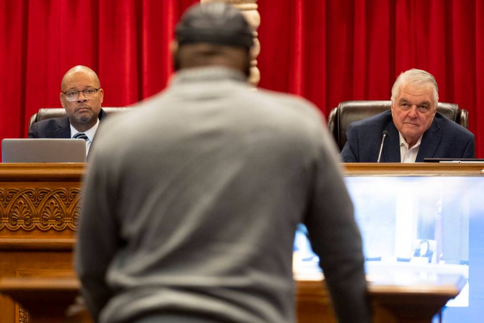 Nevada Attorney General Aaron Ford, left, and Gov. Steve Sisolak, listen to former Nevada death ...