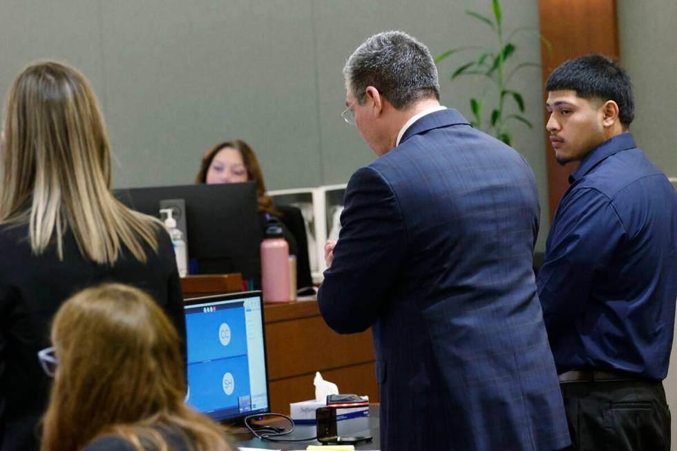 Joshua Estrada, right, stands next to his attorney John Turco while Turco speaks during Estrada ...