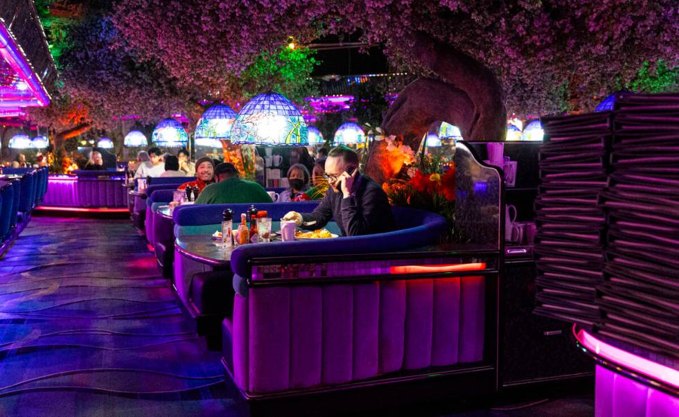 A man takes a call while dining in a booth at Peppermill on Tuesday, Dec. 13, 2022, in Las Vega ...