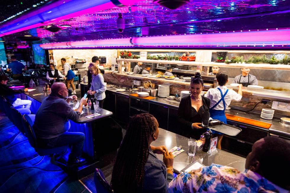 A cocktail waitress checks on customers at Peppermill on Tuesday, Dec. 13, 2022, in Las Vegas. ...