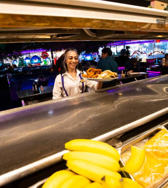 Waitress Marilyn Velez grabs a dish at Peppermill on Wednesday, Dec. 14, 2022, in Las Vegas. Th ...