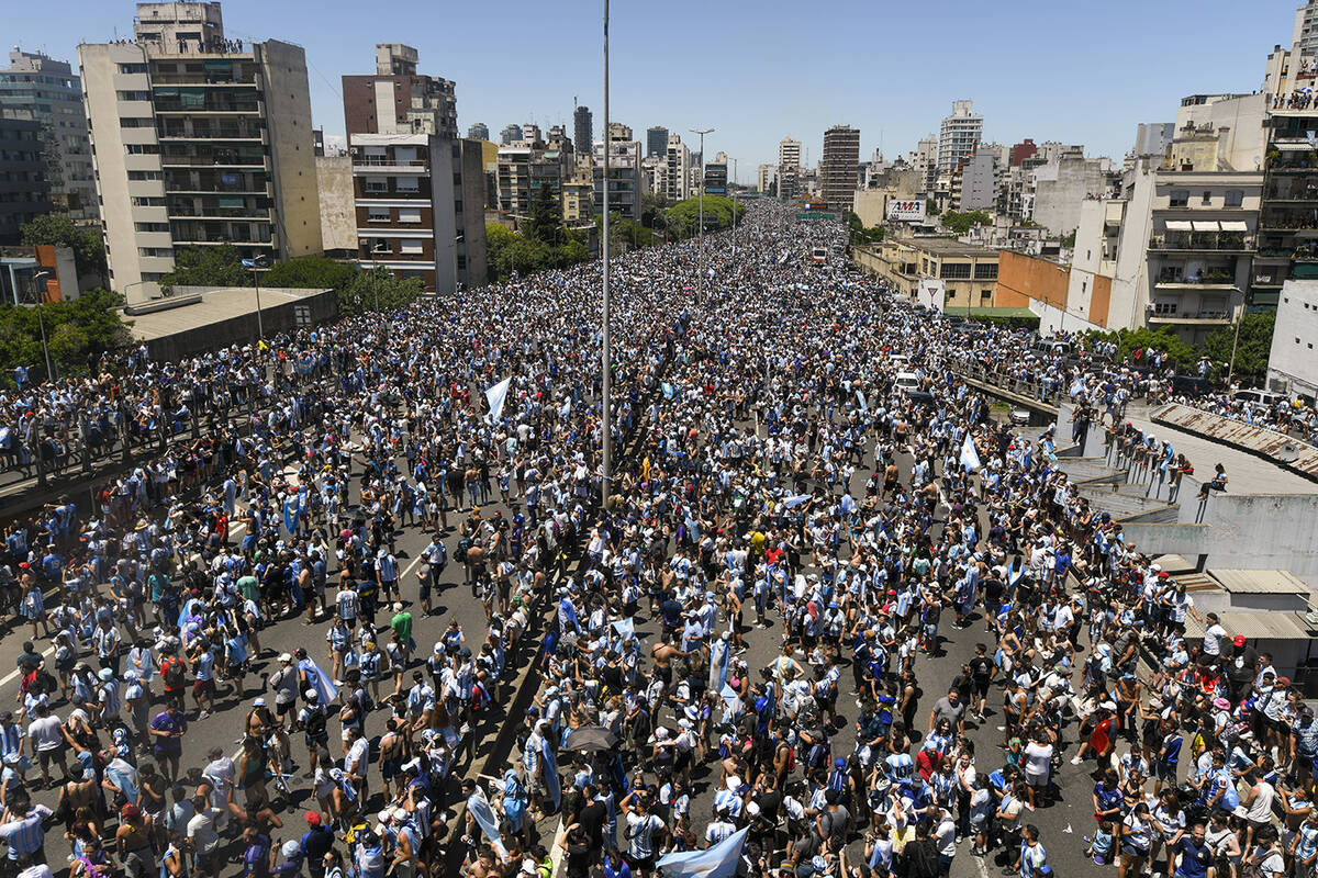Argentine soccer fans crowd a highway for a homecoming parade for the Argentine soccer team tha ...