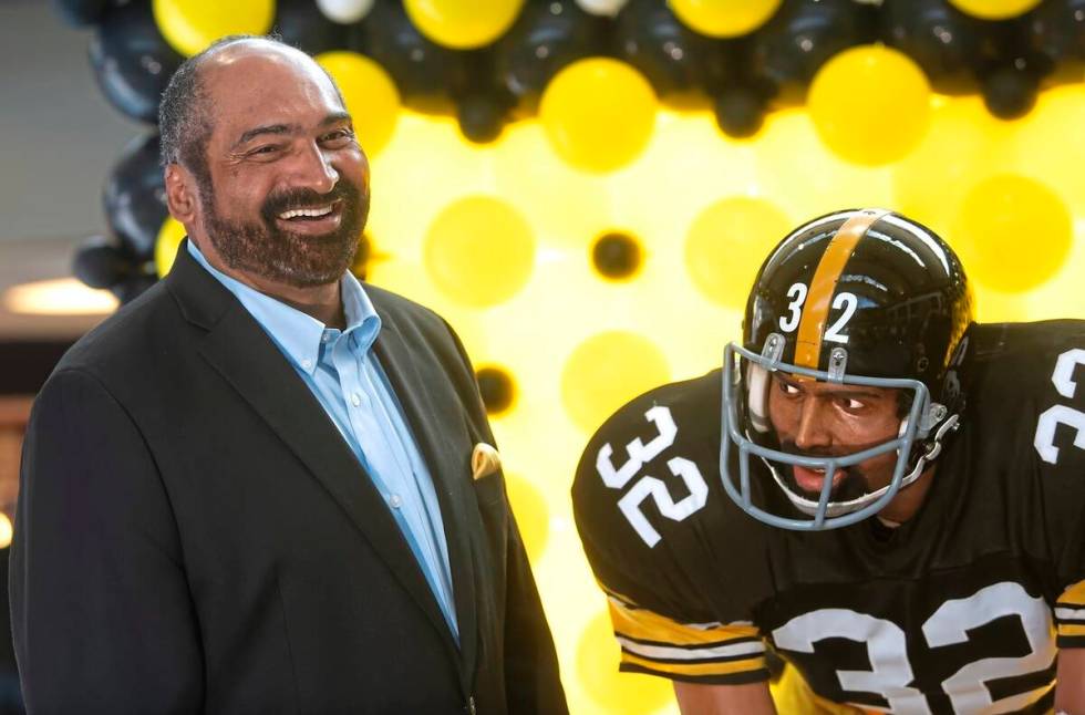 FILE - Former Pittsburgh Steelers running back Franco Harris stands next a statute of himself o ...