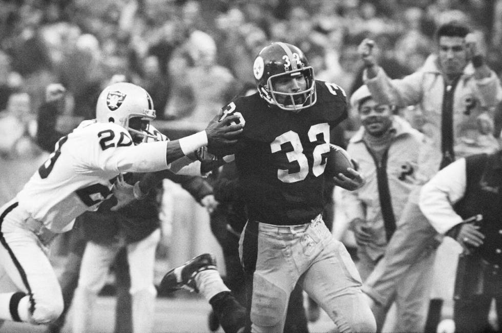 FILE - Pittsburgh Steelers' Franco Harris (32) eludes a tackle by Oakland Raiders' Jimmy Warren ...