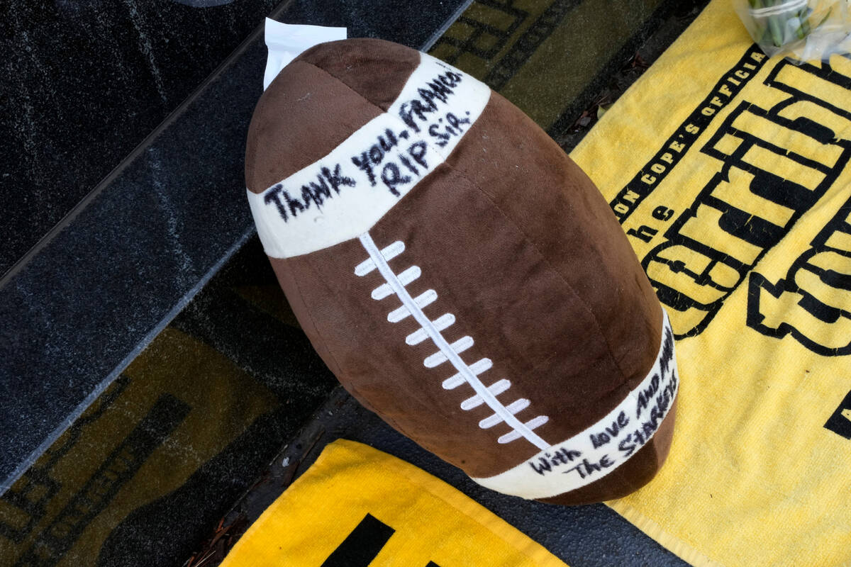 A stuffed football is placed at the Immaculate Reception memorial outside Acrisure Stadium on t ...