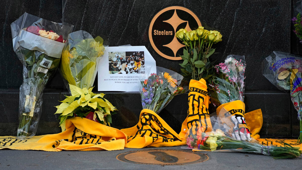 Flowers and Terrible Towels are placed at Immaculate Reception memorial outside Acrisure Stadiu ...