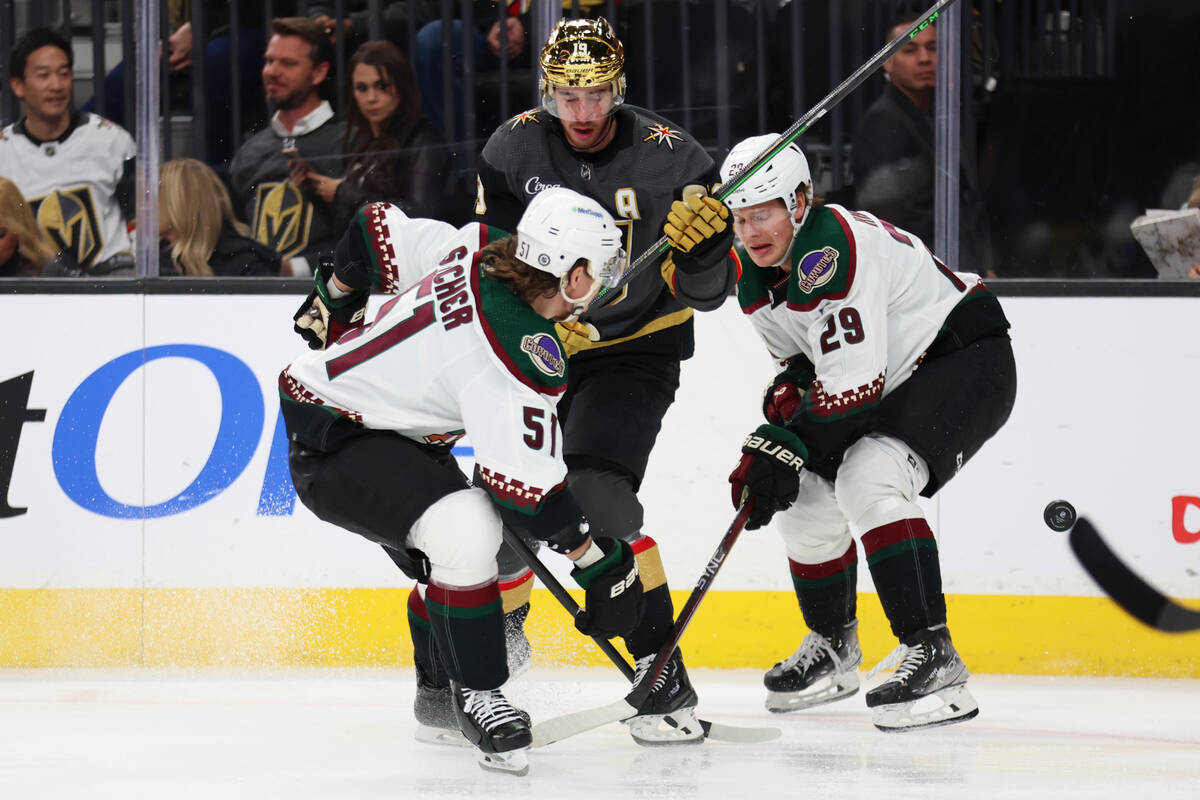 Vegas Golden Knights right wing Reilly Smith (19) fights for the puck against Arizona Coyotes d ...