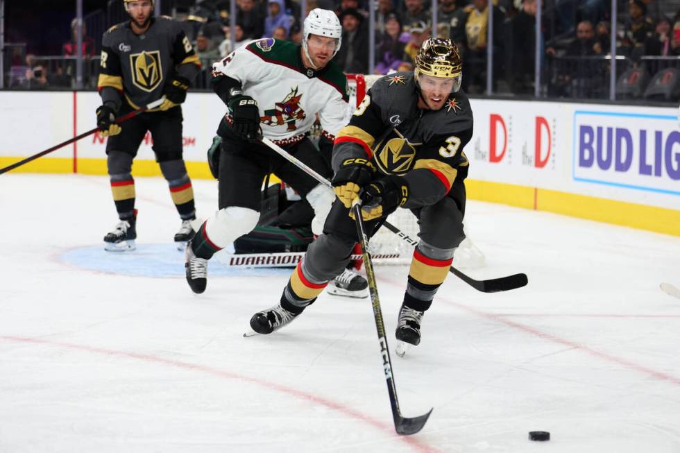 Vegas Golden Knights defenseman Brayden McNabb (3) reaches for the puck under pressure from Ari ...