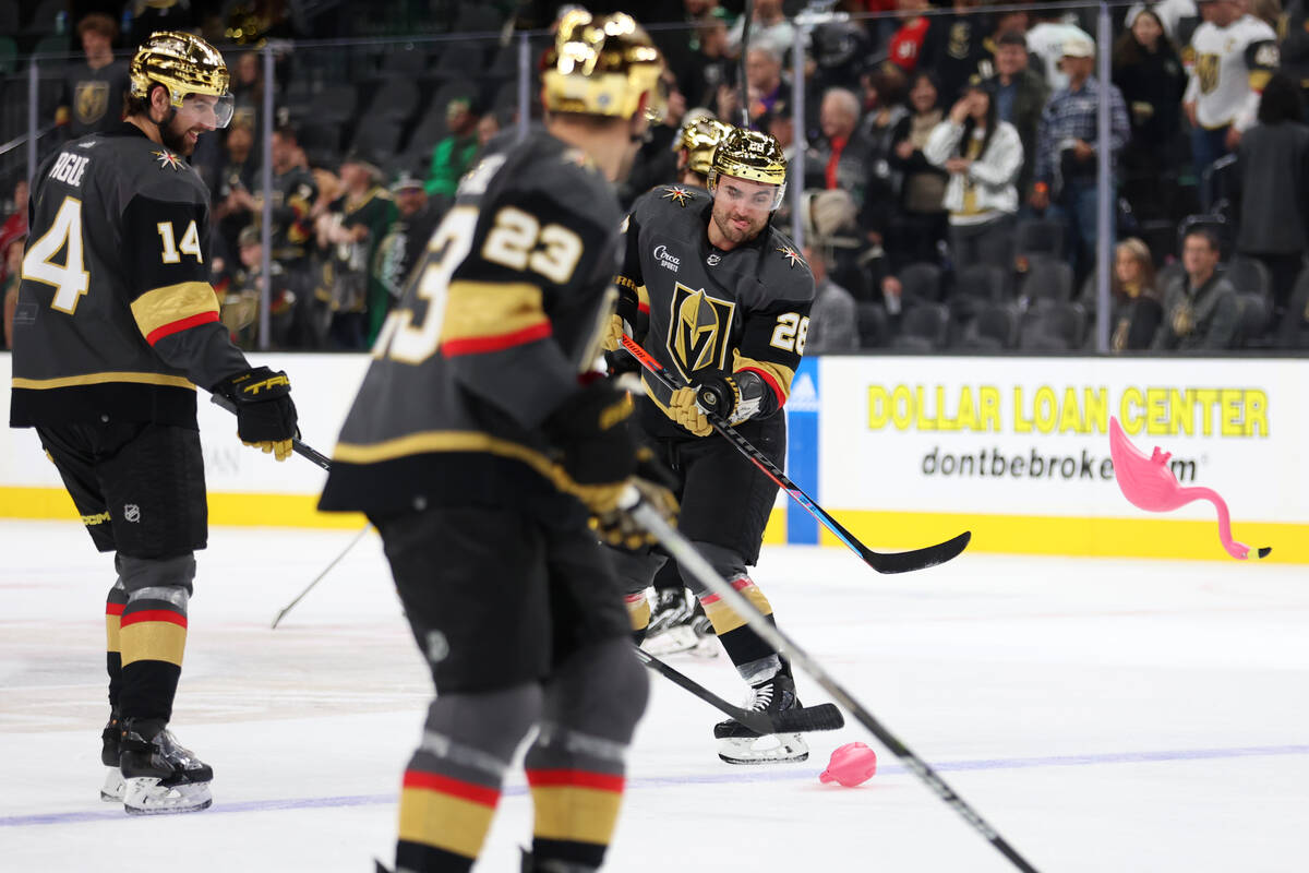 Vegas Golden Knights left wing William Carrier (28) hits a toy flamingo off the ice following a ...