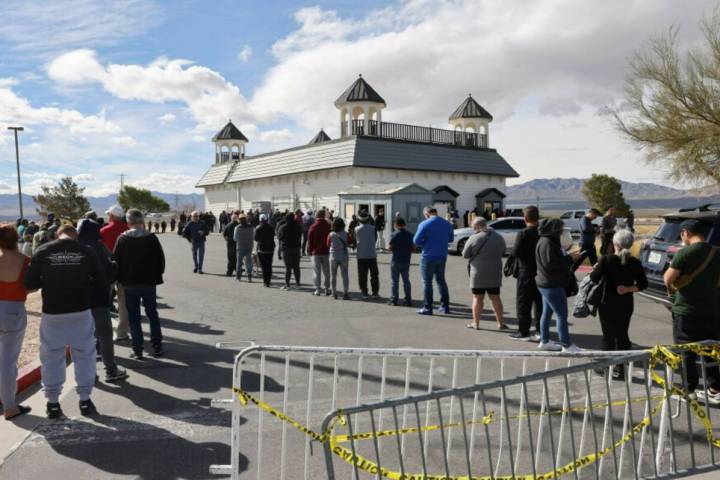 People wait in line to buy lottery tickets at the Lotto Store just across the Nevada/California ...